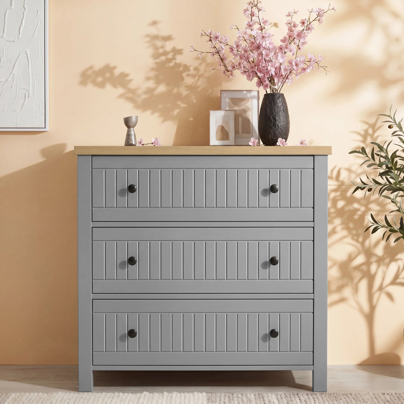[Grey] Chest of drawers from Linra bedroom furniture set styled with vase and round mirror on panelled wall
