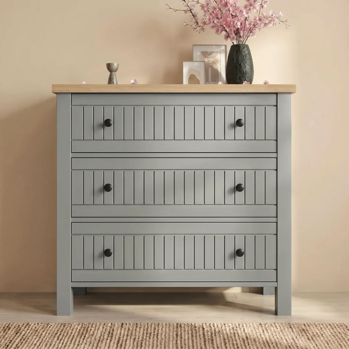 [Grey] Linra Painted 4 Piece Bedroom Furniture Set Grey showcasing the front view of the three-drawer slatted chest.