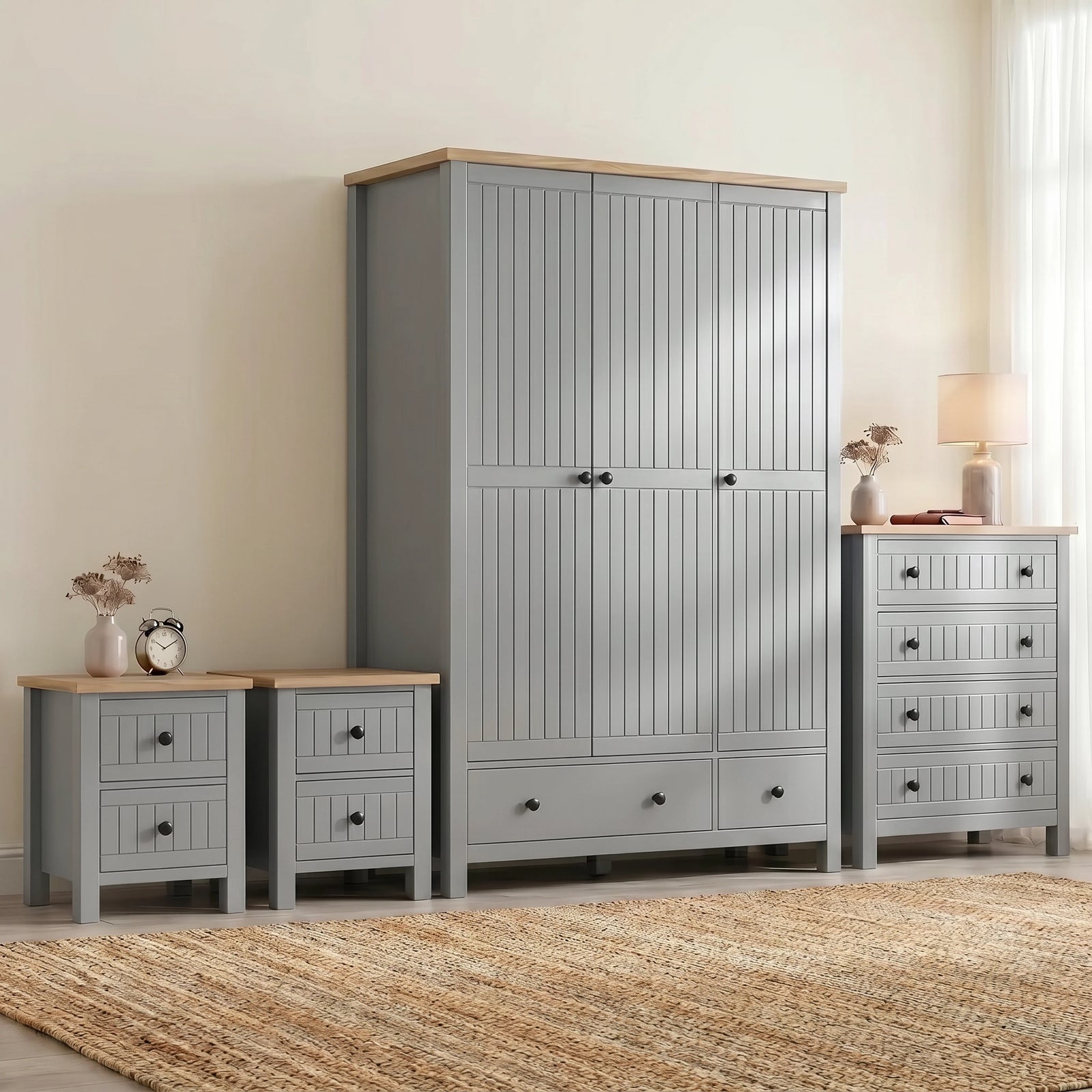 [Grey] Linra Painted 4 Piece Bedroom Furniture Set Grey grouped against a cream wall with two bedside tables, a tall chest, and a double wardrobe with oak tops on a jute rug