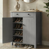 [Grey] Linra shoe cabinet with left door open showing four shelves holding heels, boots, and sandals in a warm hallway
