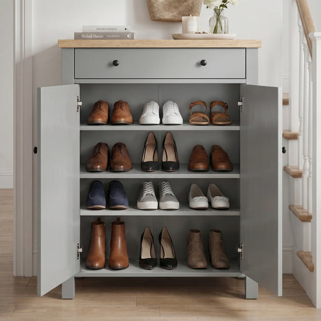 [Grey] Linra Grey 4 Tier Painted Shoe Storage Cabinet With Drawer three-quarter view in styled hallway with staircase, coat hooks and flowers on oak top