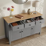 [Grey] Linra open drawer view showing notebook, keys, sunglasses, folded cloth, cosmetics, and black knobs