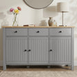 [Grey] Linra straight front detail showing three drawers, beadboard doors, oak-effect top, lamp, and vases