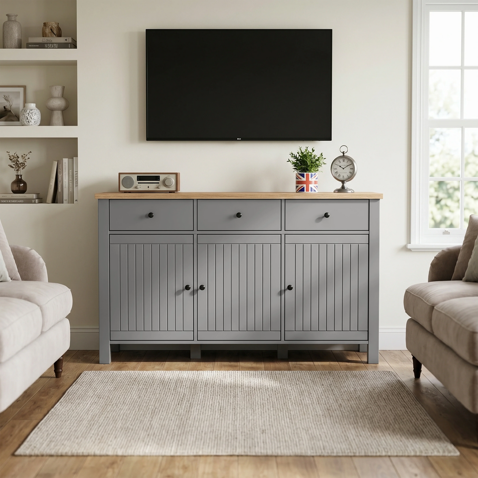 [Grey] Linra TV room view with sideboard under wall screen, oak-effect top, clock, plant, radio, and shelves