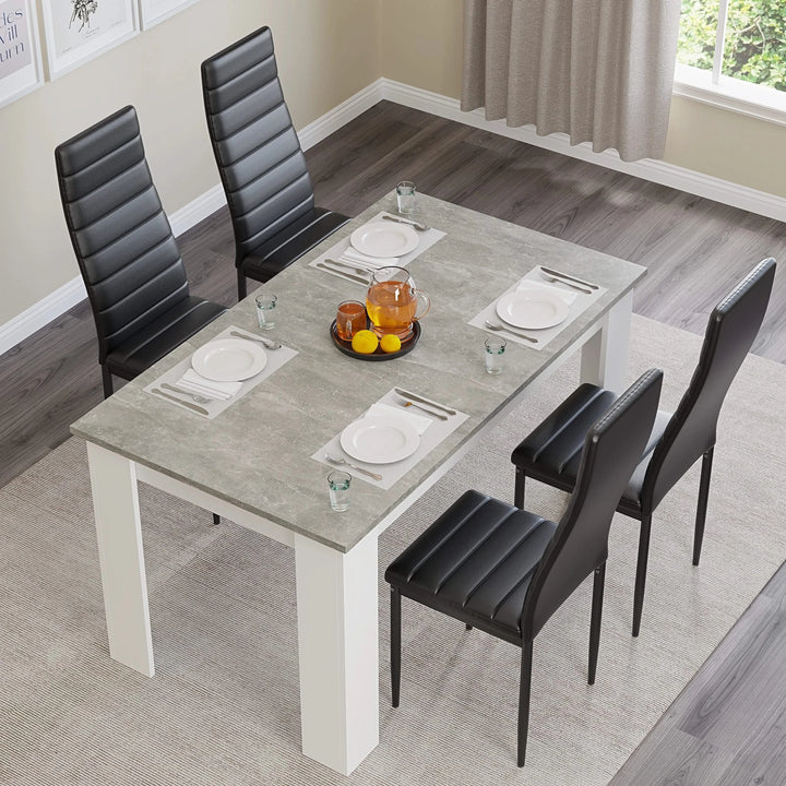 [4 Seater | Black] Top-angled: grey marble 4 seater table, 4 black chairs, plates, orange bowl