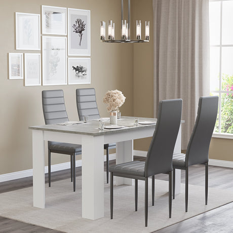 4 seater grey marble dining table set with grey chairs in a cozy dining room with wall art and chandelier.