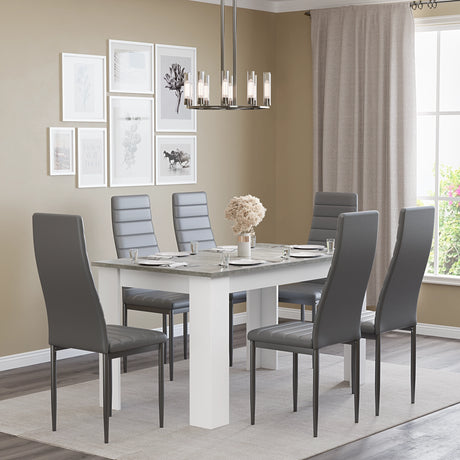 spacious 6 seater dining table in grey marble finish with soft grey chairs, ideal for entertaining guests at home.