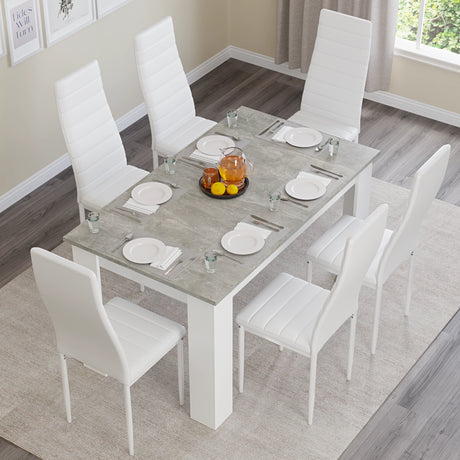 cheap dining table and chairs set with white leather chairs and grey marble tabletop offering a high-end aesthetic on budget