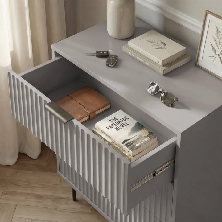 [Grey] Flutrina bedside table top drawer pulled out showing tan leather wallet inside, books and vase on top surface