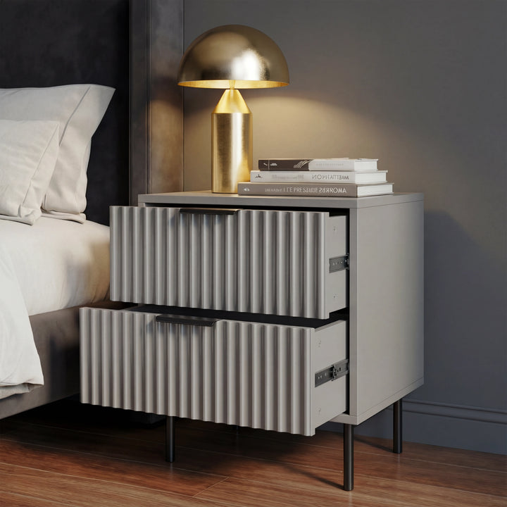 [Grey] Flutrina bedside table with two drawers and black legs, placed in a bedroom on a wooden floor