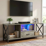 [Grey Oak] Calvera TV unit lifestyle below wall-mounted TV, motorbike model on warm-LED centre shelf, pampas in vase right