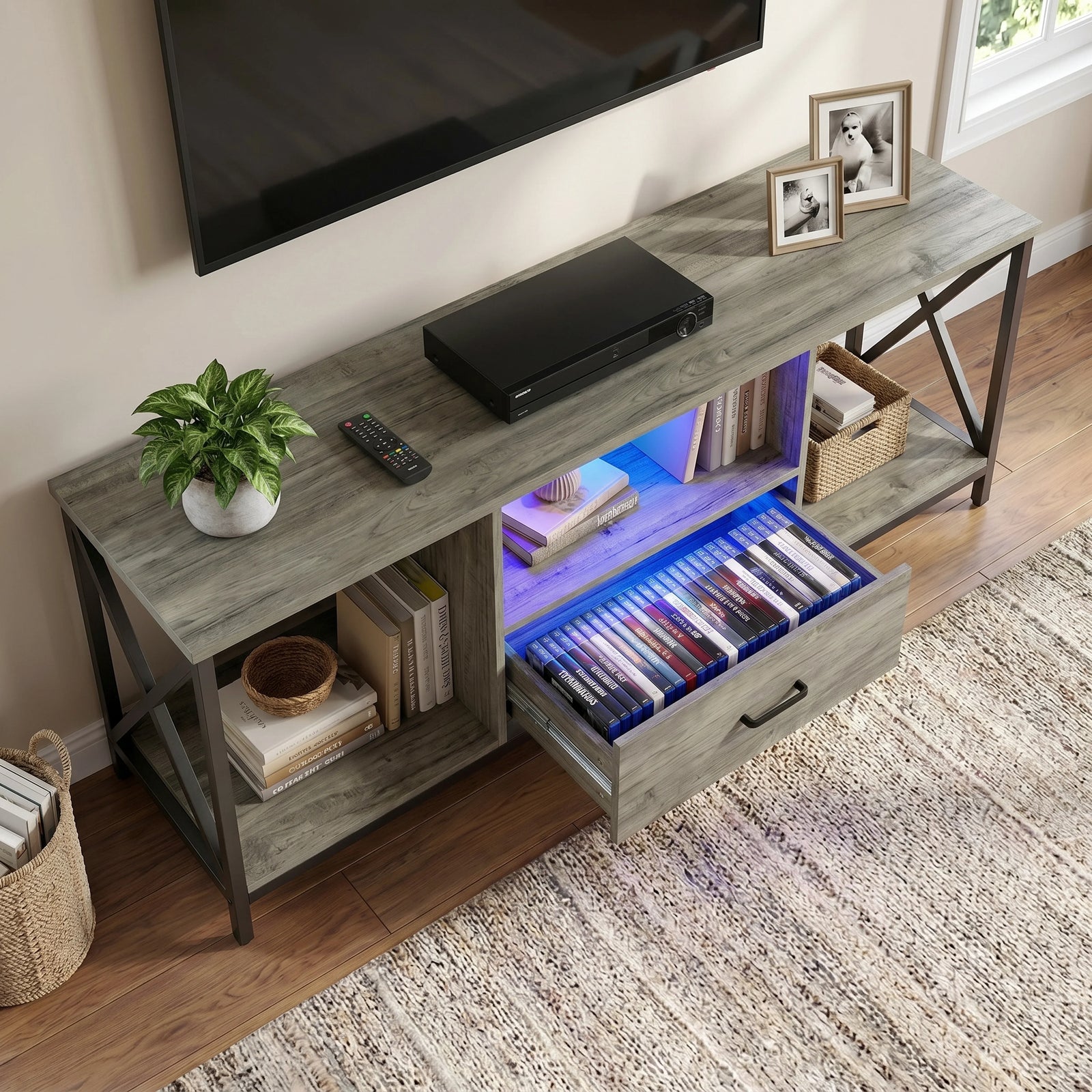 [Grey Oak] Calvera TV unit demonstrating drawer capacity, vertical disc cases lined up across the open compartment