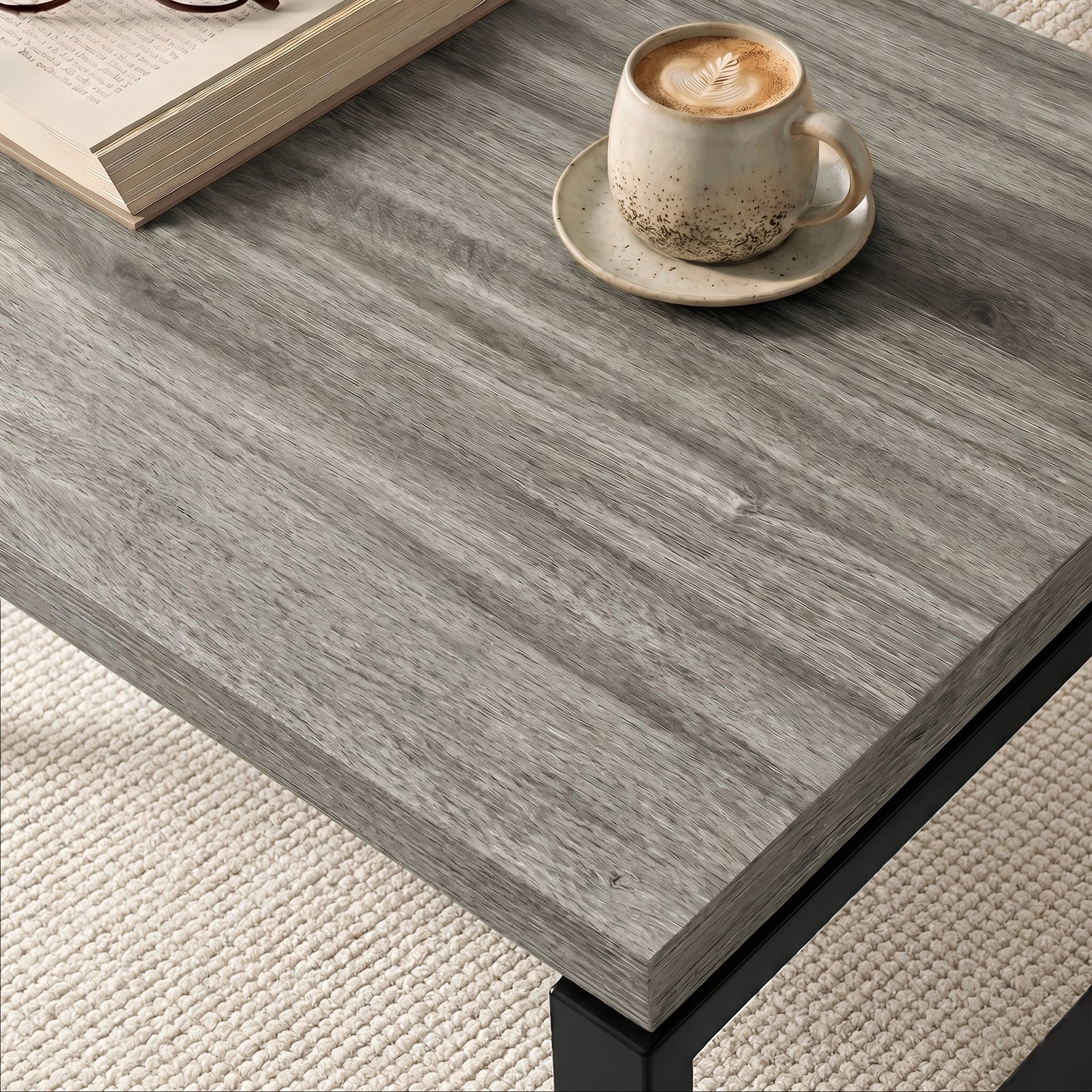 [Grey Oak] Nestline tabletop detail with a small cup on grey wood grain and softly layered edge lines