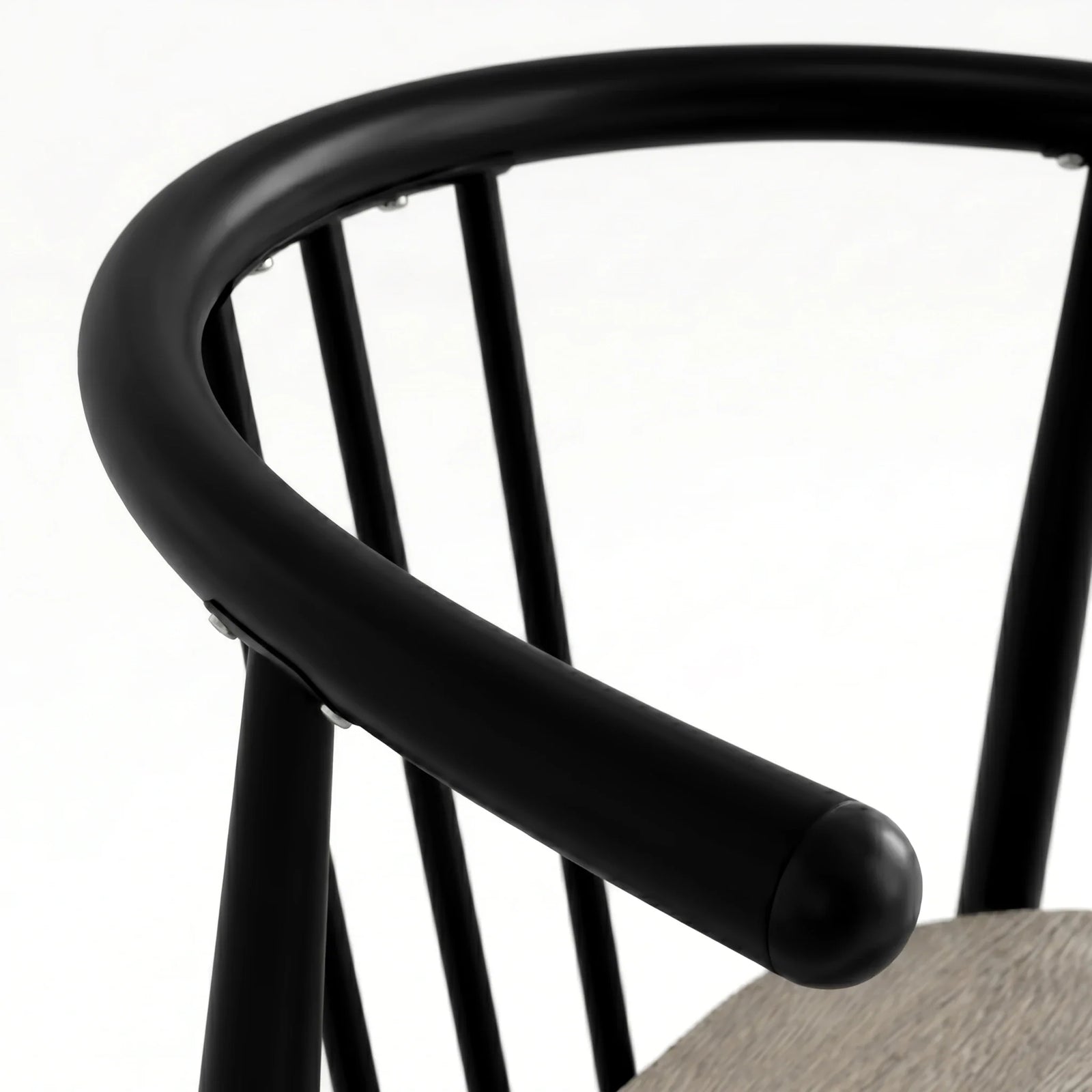 [Grey] Torvi chair curved matte black metal backrest and armrest detail with rounded end cap close-up