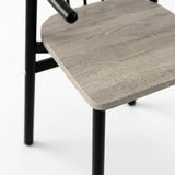 [Grey] Torvi chair close-up of rounded grey oak seat pad resting on black powder-coated metal frame legs