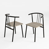 [Grey Oak] Two Torvi dining chairs on white background showing black curved metal frame and grey oak wood seats
