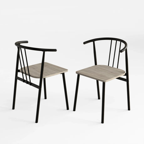 [Grey Oak] Two Torvi dining chairs on white background showing black curved metal frame and grey oak wood seats