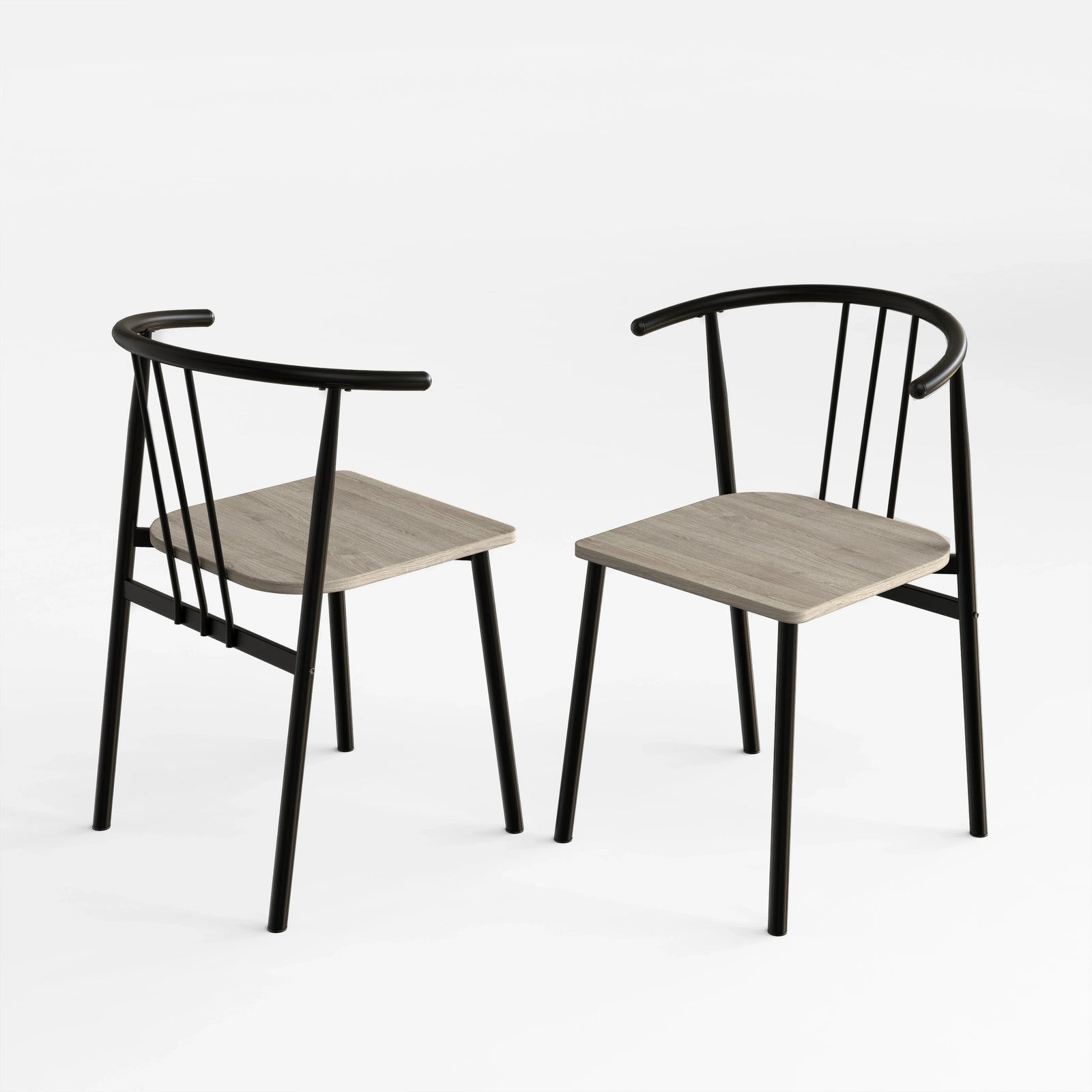 [Grey] Two Torvi dining chairs on white background showing black curved metal frame and grey oak wood seats