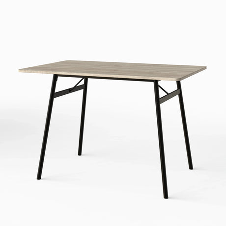 [Grey Oak] Torvi dining table angled on white background showing grey oak MDF top and black metal A-frame legs