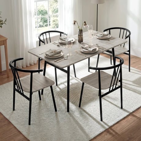 [Grey Oak] Torvi dining table angled close-up of grey oak surface with chairs and vase in a bright dining room