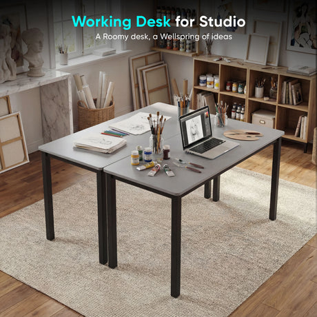 [100 X 50 cm] Office Desk arranged in artist studio with sketches, paint tubes, brushes in jars, pencils, and laptop on a soft area rug
