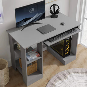 [Grey] Angled grey computer desk view showing monitor, mouse, pull-out keyboard tray and gaming PC tower below