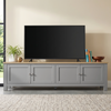 [Grey] Oskara TV unit 180cm main lifestyle shot with large TV on top, plant, warm tiled floor