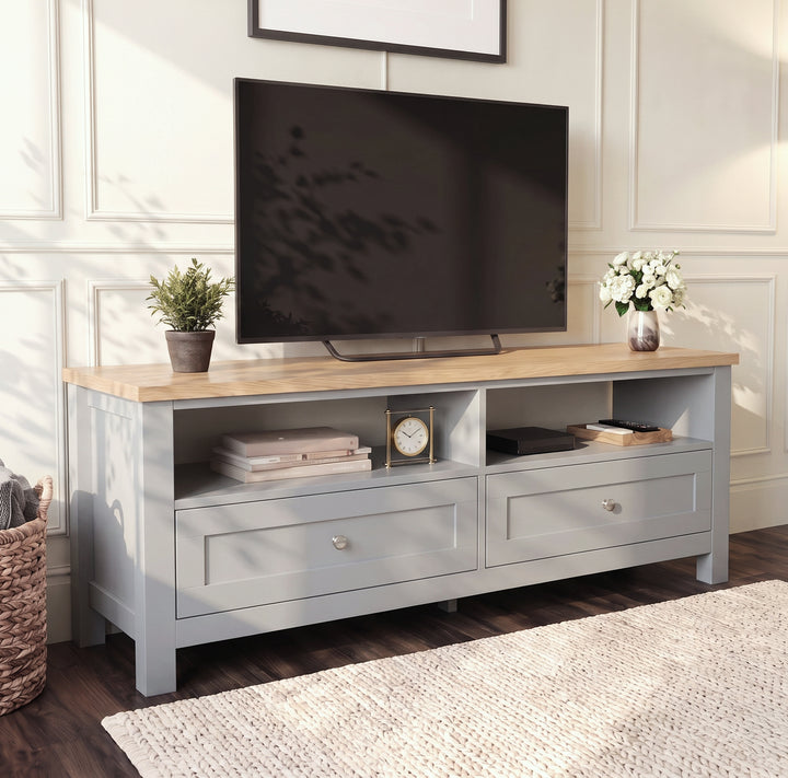 [Grey] Angled view of the Oskara Grey Painted TV Unit styled with a TV, plants, and decorative home accessories.