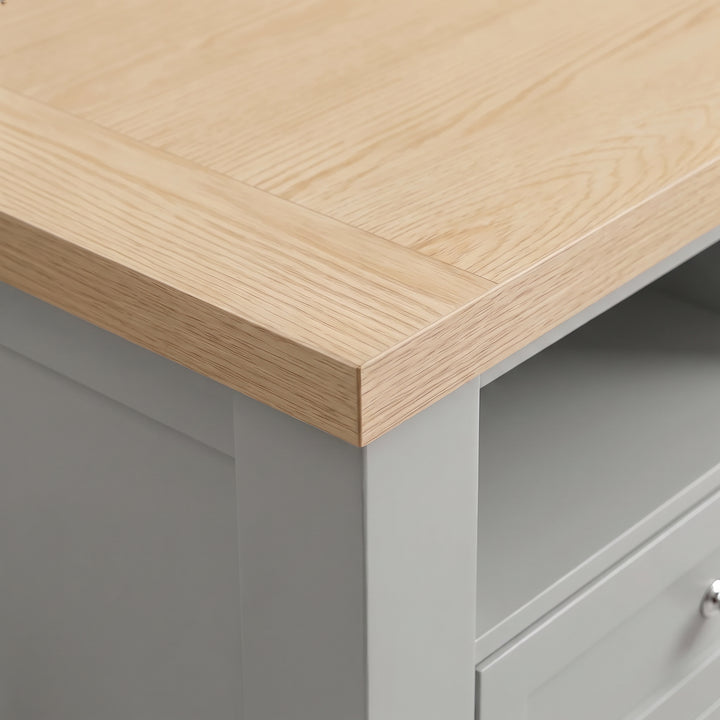 [Grey] Close-up detail of the natural oak effect top surface corner on the Oskara Grey Painted TV Unit.