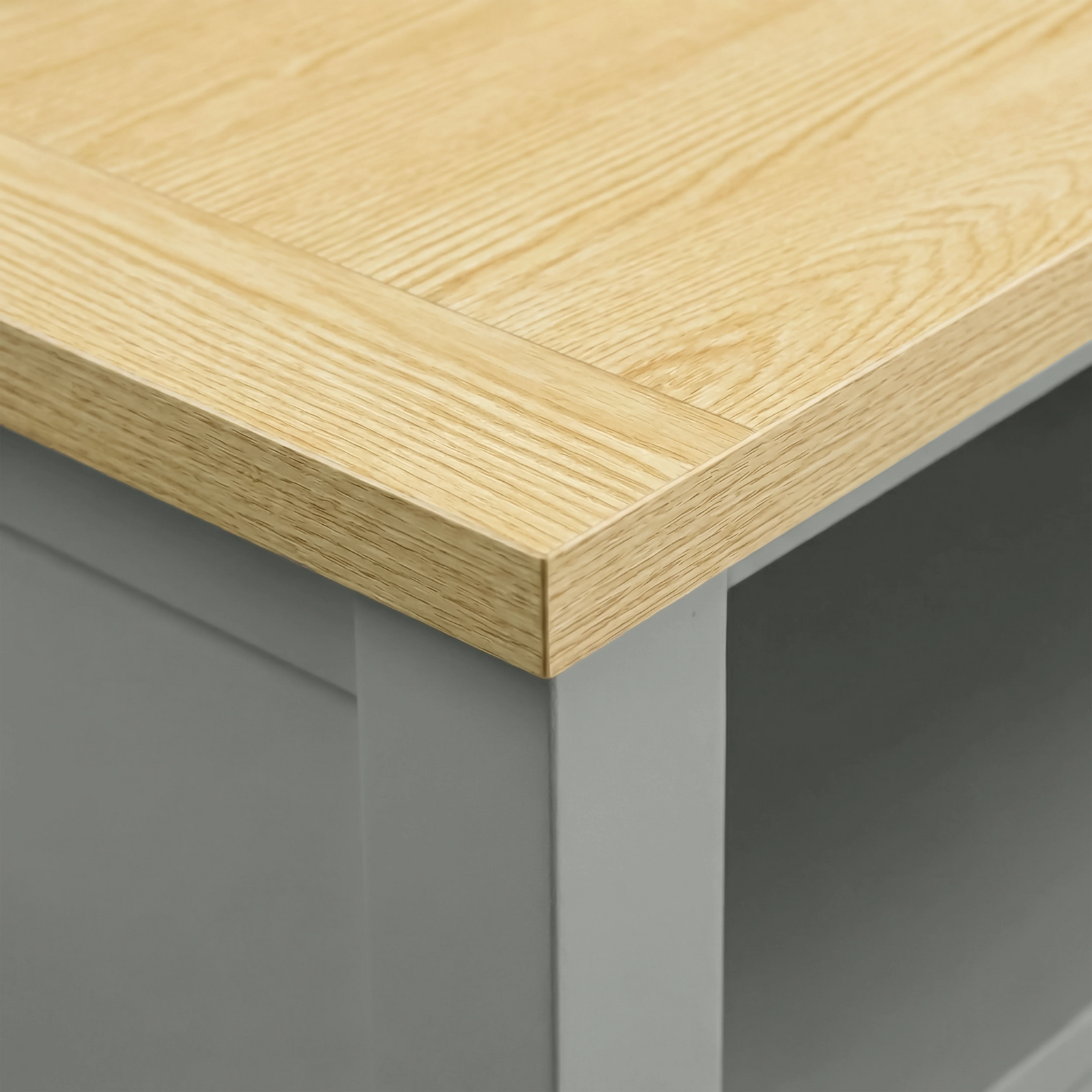[Grey] Oskara TV unit close-up of natural oak top surface showing wood grain texture and corner edge against grey painted frame