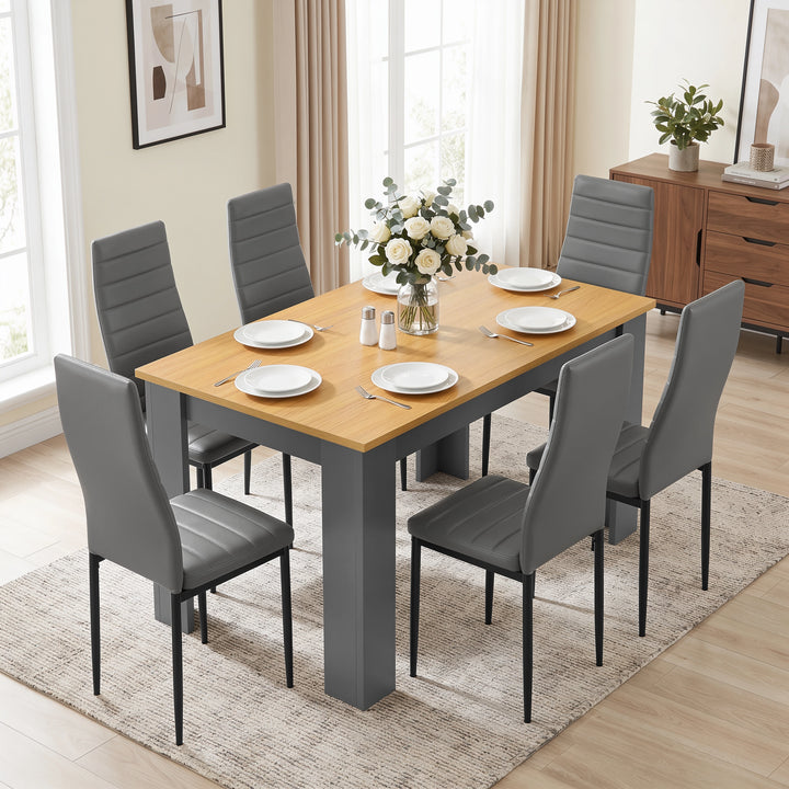 [Grey & Pine] Dining set angled in bright room with six chairs, laid table, flowers, and sideboard.