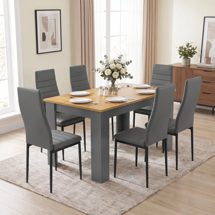 [Grey & Pine] Dining table and six chairs in bright room, shown from a low front angle with wall art.
