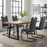 [Grey] Four high-back dining chairs with black loop frames around a wood table styled with a glass plant vase.