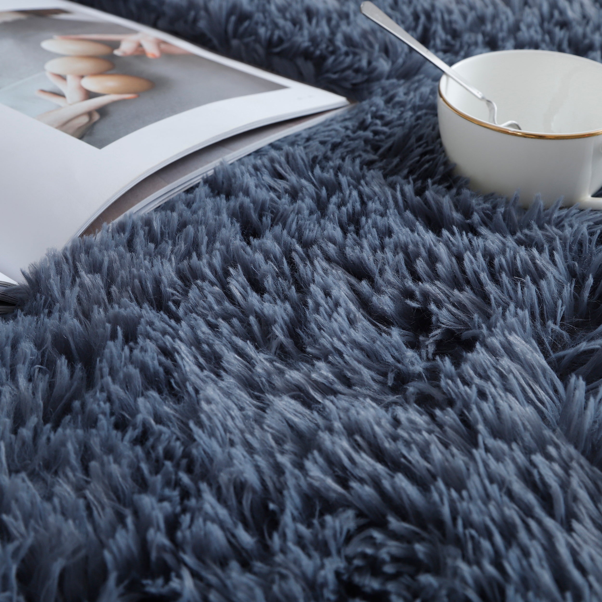 Close-up of grey shaggy rug with soft fluffy texture, perfect for a cozy and modern living space