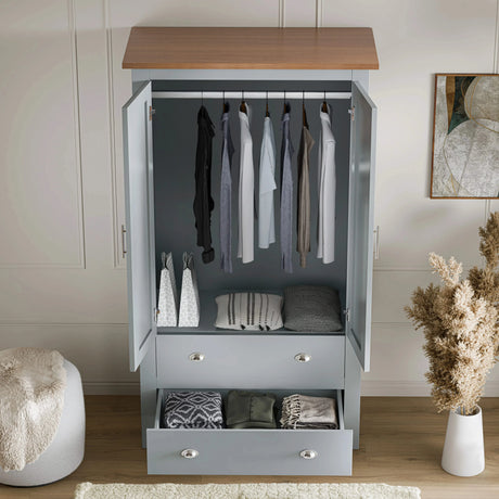 [Grey] shaker double door wardrobe opened, showing hanging rail, top shelf and two drawers below, placed on a wooden floor