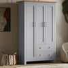 grey shaker triple wardrobe with shelves and drawers featuring 2 bottom drawers, and a wooden top for bedroom storage