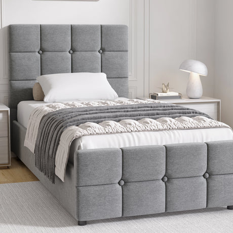 Gray upholstered bed with tufted headboard in a bedroom setting