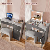 Grey vanity table with closed and open compartments, featuring a laptop and mirror.