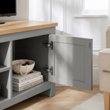 [Grey] Tavero corner TV unit cabinet door swung open showing stacked books and ceramic vase inside