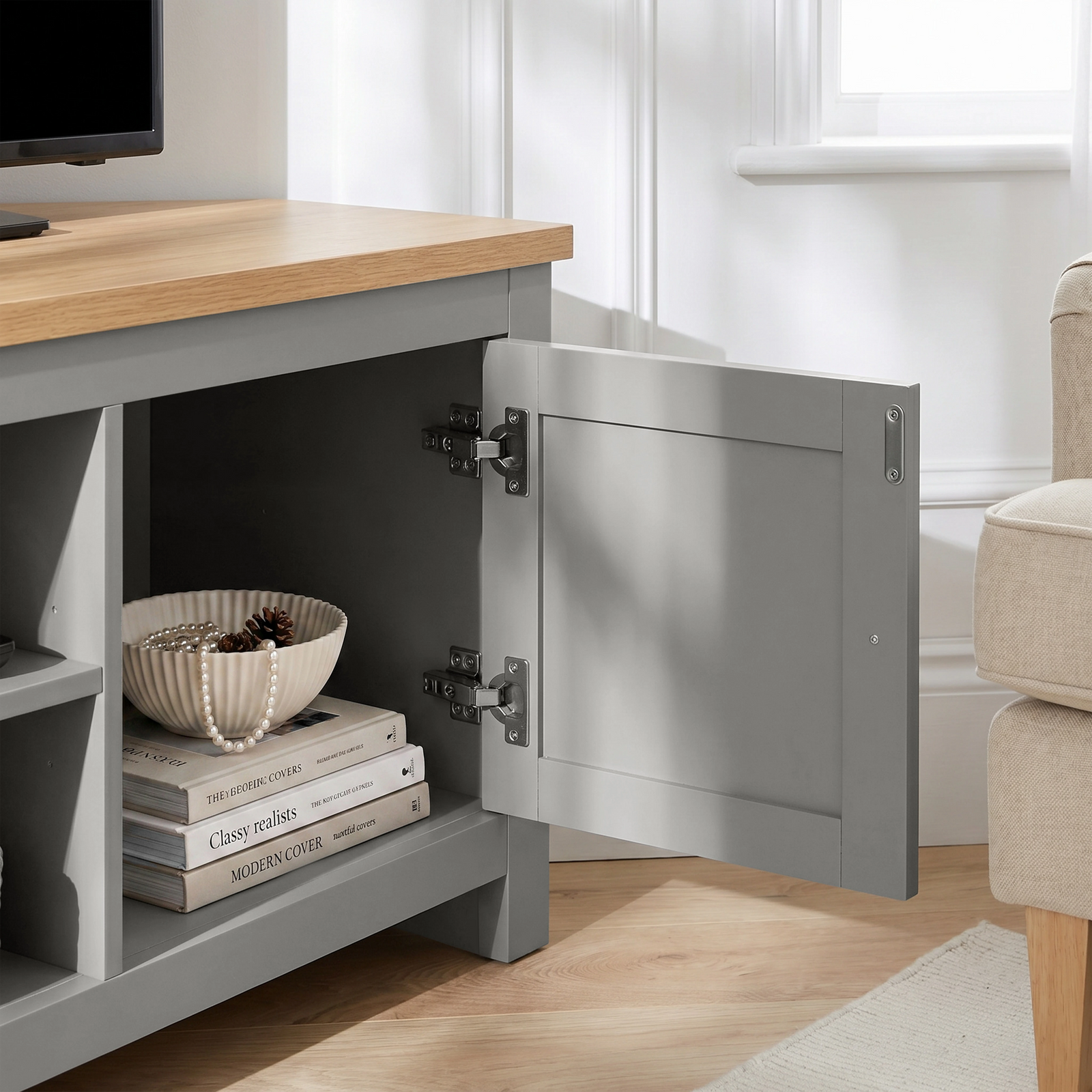 [Grey] Tavero corner TV unit cabinet door swung open showing stacked books and ceramic vase inside