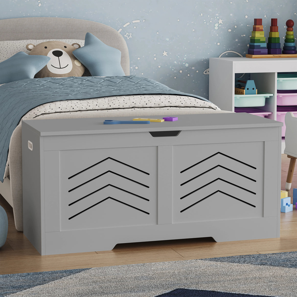 Gray toy storage box with chevron pattern in a child's bedroom.