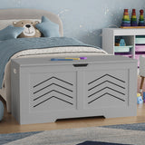 Gray toy storage box with chevron pattern in a child's bedroom.