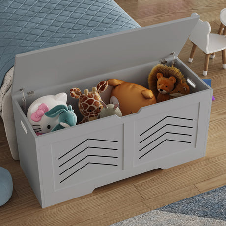 White toy storage box with black patterns filled with stuffed animals on a wooden floor.