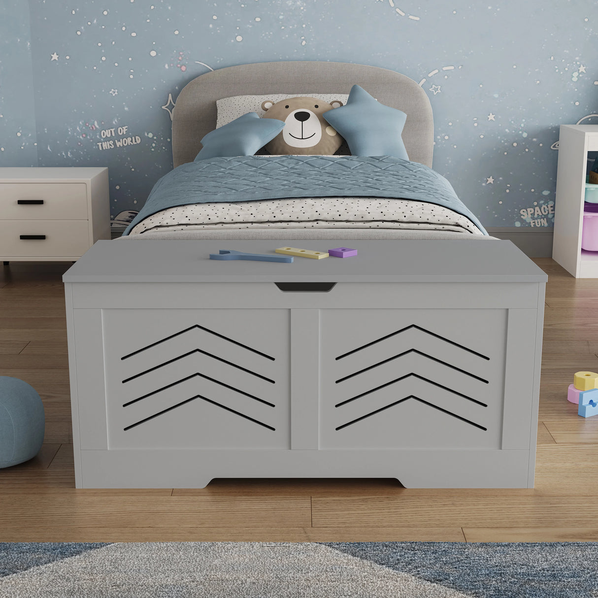 Toy Storage Box - Kids Storage Chest Blanket Box with Safety Hinges in grey with arrow design, placed in a child's bedroom with a teddy-themed bed.