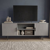 Modern grey TV entertainment unit with vertical fluted doors and silver legs for a contemporary living room aesthetic.