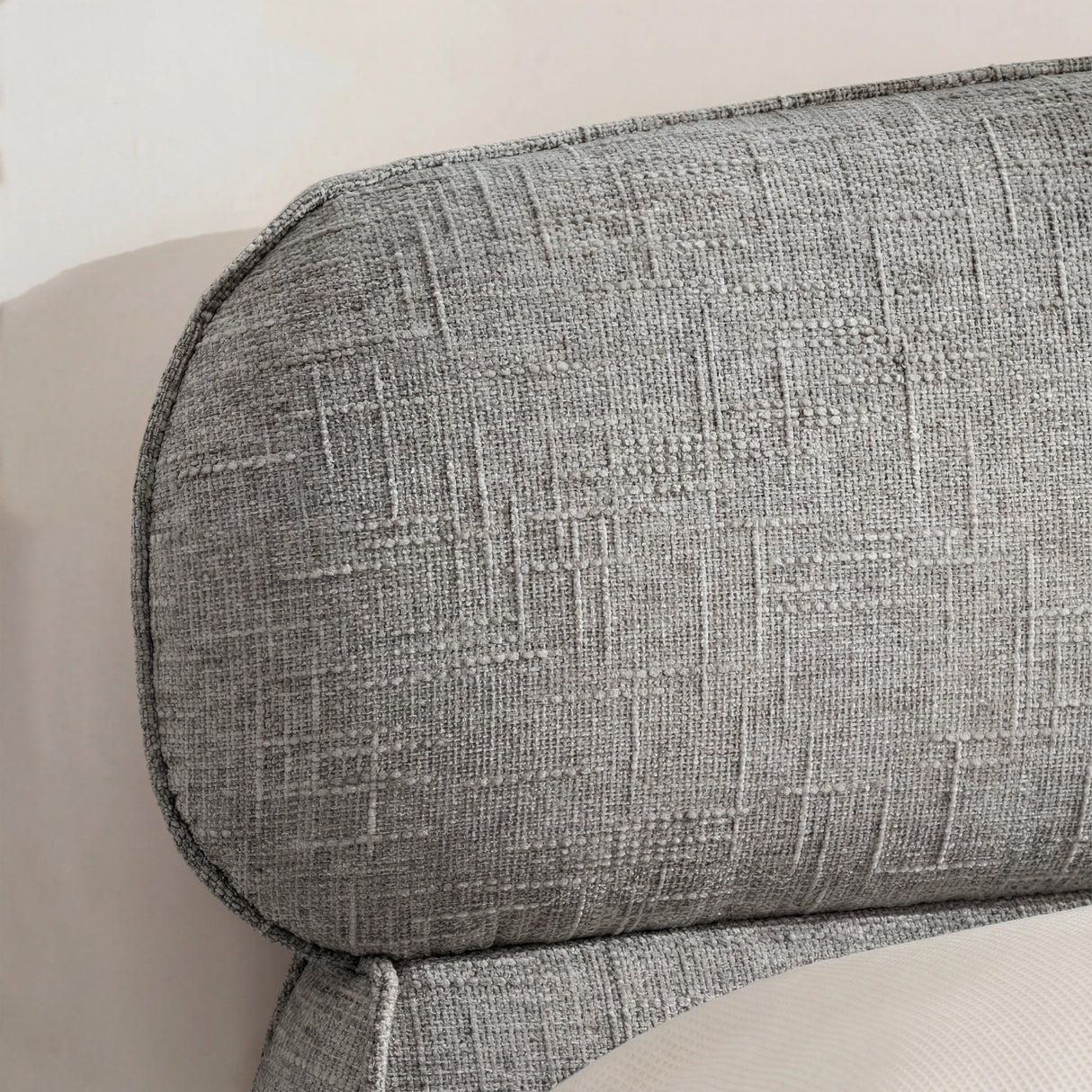 Close view of the softly rounded back cushion of the double bed frame, showing textured grey upholstery