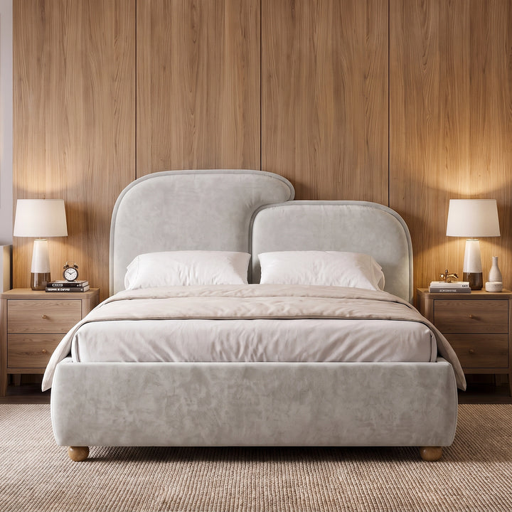 [Double | Grey] Front view grey king ottoman bed frame centered between wooden nightstands with warm lamps and wall art
