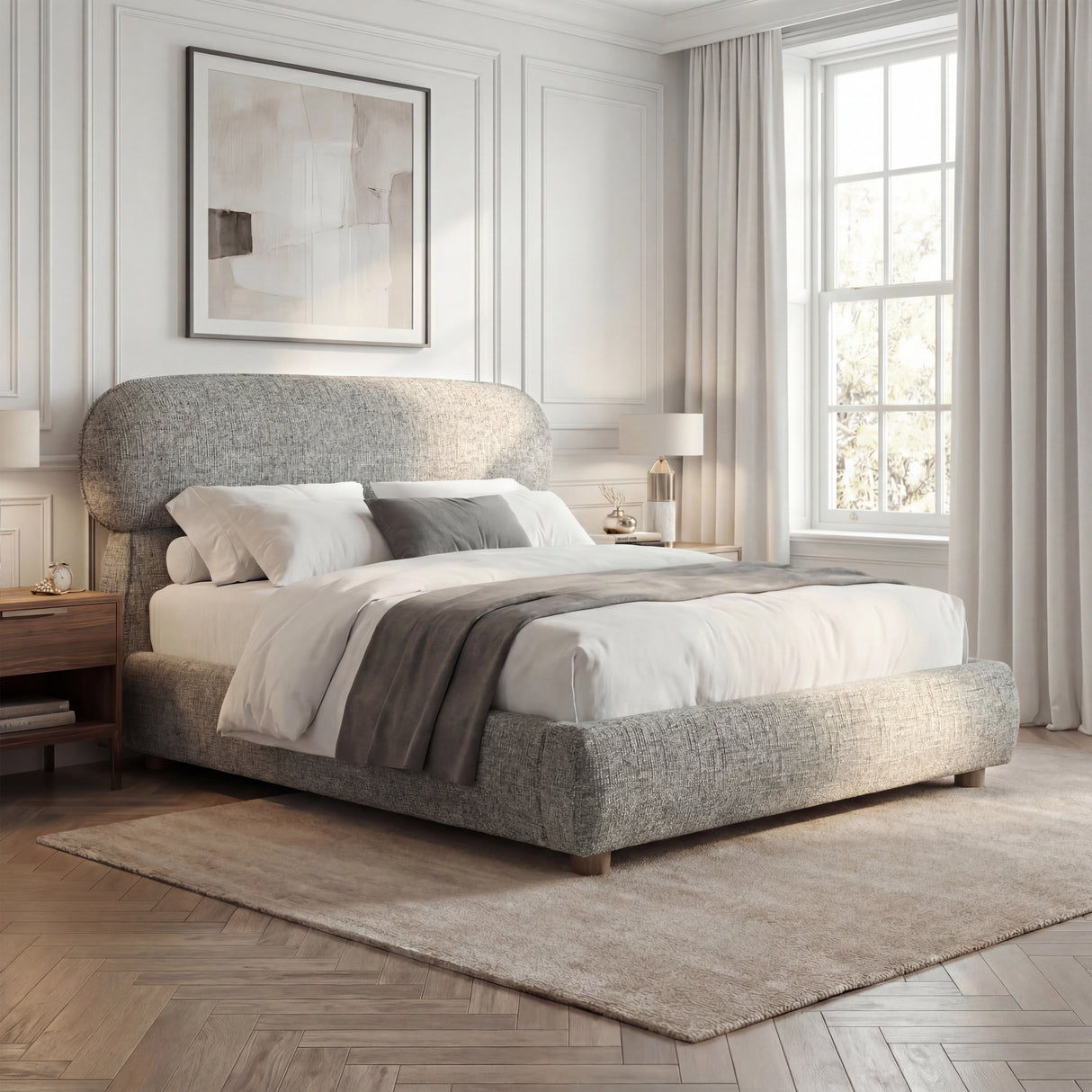 Grey upholstered double bed frame placed with neutral bedding and natural daylight from windows