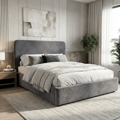 Grey velvet double ottoman storage bed placed in a neutral bedroom with upholstered frame and padded headboard