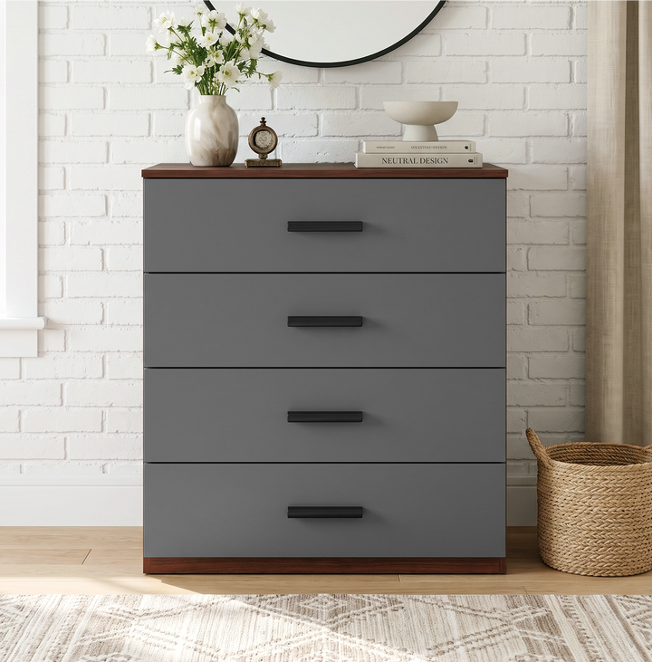 [Walnut] Front view of a modern grey and walnut 4-drawer dresser with black handles styled against a white brick backdrop